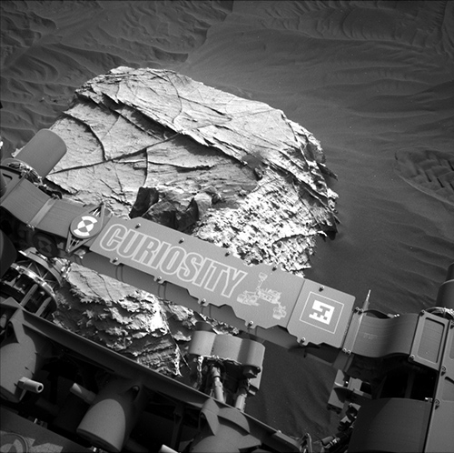 Mars surface and part of the rover are visible in this image