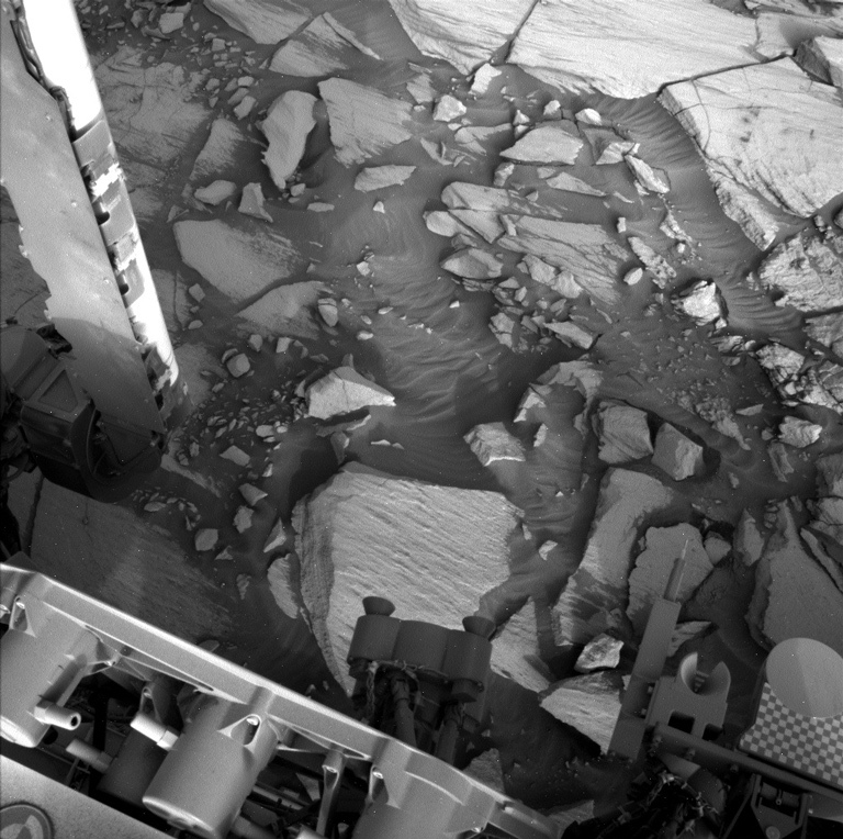 Part of the rover and Mars' surface seen by the left navigation camera onboard Curiosity