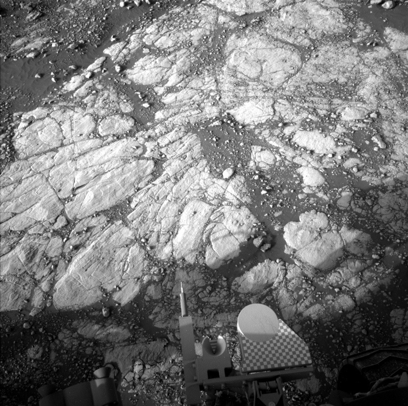 Part of the Curiosity rover is visible in this image of Mars