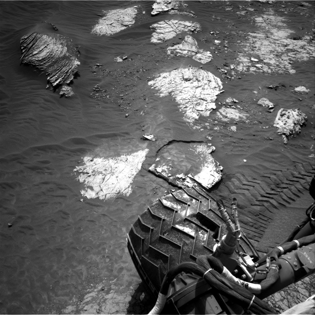 surface of Mars and one wheel of Curiosity rover
