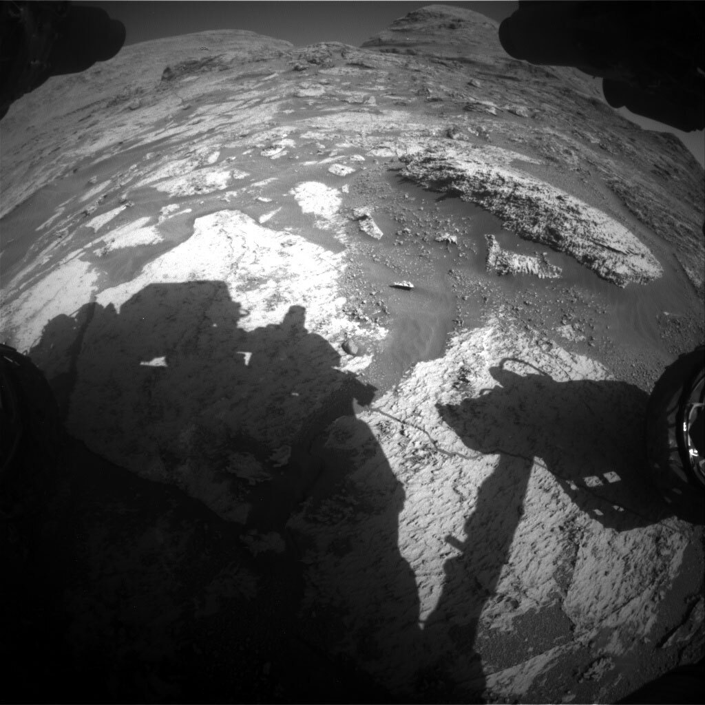This black and white image was taken by Front Hazard Avoidance Camera (Front Hazcam) onboard NASA's Mars rover Curiosity on Sol 3163. It shows the rocky surface of Mars.