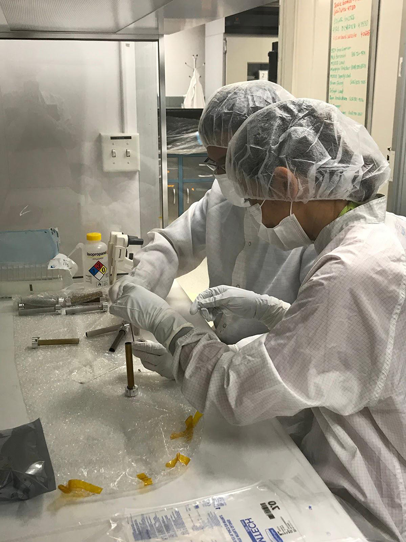 Engineers clean the tubes that will store Martian rock